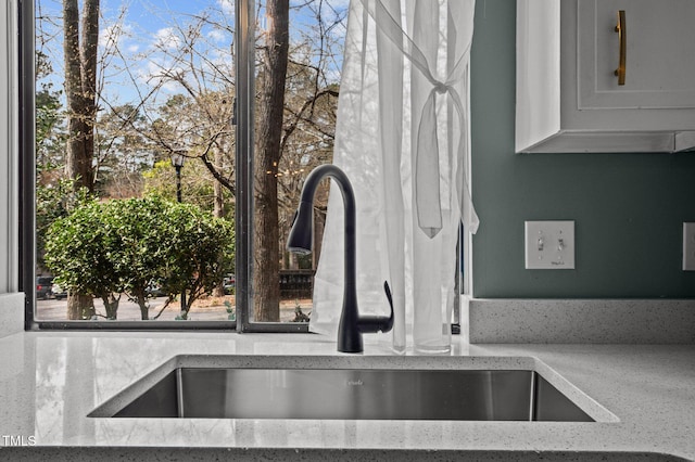 details with light stone counters and a sink