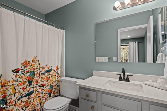 full bathroom with toilet and vanity