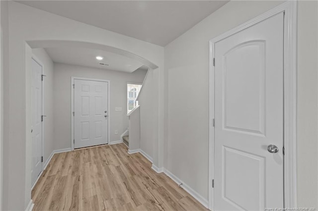 524 Mineral Spring Ln, Fuquay Varina, NC 27526 - interior space featuring baseboards, arched walkways, stairway, and light wood-style floors