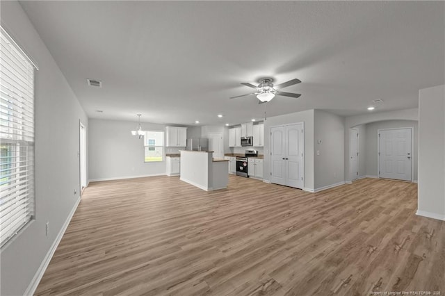 524 Mineral Spring Ln, Fuquay Varina, NC 27526 - unfurnished living room with baseboards, visible vents, ceiling fan with notable chandelier, and light wood finished floors