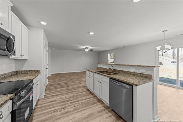 524 Mineral Spring Ln, Fuquay Varina, NC 27526 - kitchen featuring white cabinets, a sink, appliances with stainless steel finishes, and light wood-type flooring