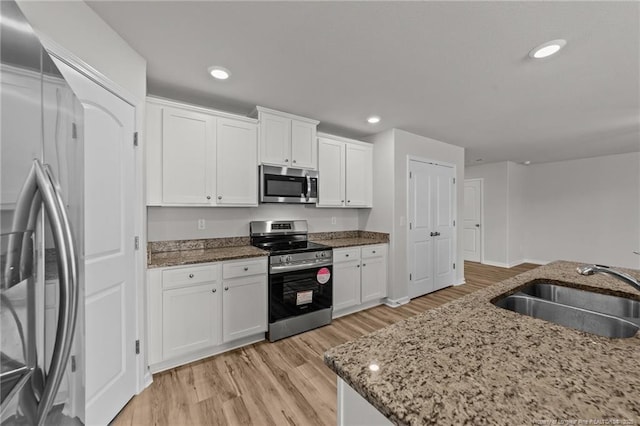 524 Mineral Spring Ln, Fuquay Varina, NC 27526 - kitchen featuring white cabinets, a sink, appliances with stainless steel finishes, and recessed lighting