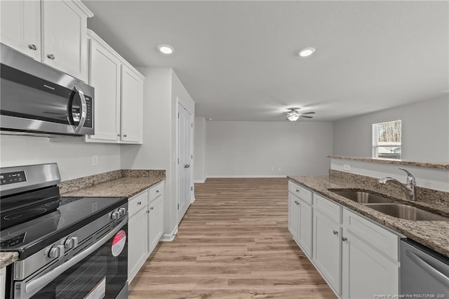 524 Mineral Spring Ln, Fuquay Varina, NC 27526 - kitchen with white cabinetry, light wood-type flooring, a sink, ceiling fan, and appliances with stainless steel finishes