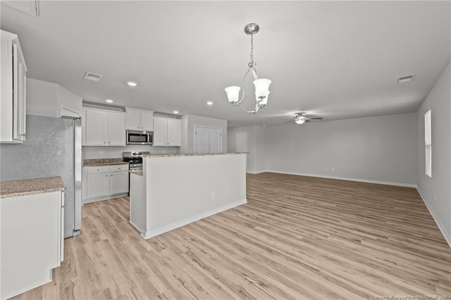 524 Mineral Spring Ln, Fuquay Varina, NC 27526 - kitchen with visible vents, stainless steel appliances, white cabinetry, light wood-style floors, and hanging light fixtures