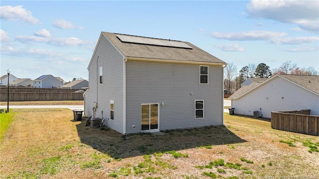 524 Mineral Spring Ln, Fuquay Varina, NC 27526 - rear view of house with central air condition unit, solar panels, fence, and a yard