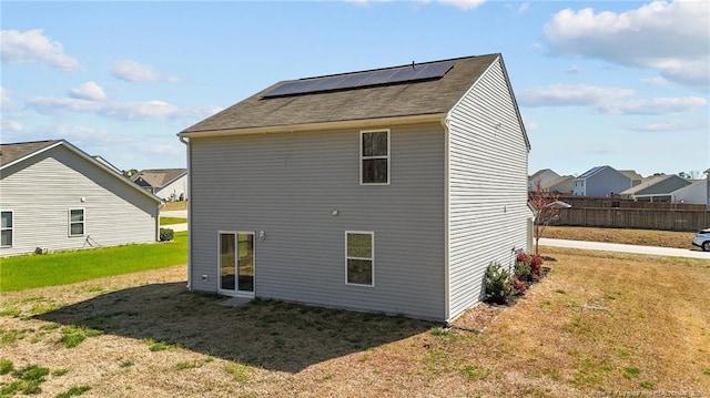 524 Mineral Spring Ln, Fuquay Varina, NC 27526 - rear view of property with solar panels, fence, and a yard