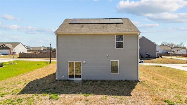 524 Mineral Spring Ln, Fuquay Varina, NC 27526 - rear view of house featuring a lawn and solar panels