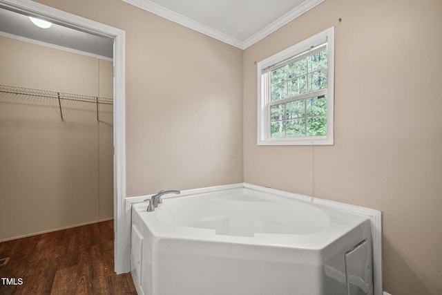 234 Rolling Hills Rd, Skipwith, VA 23968 - bathroom with a bath, a walk in closet, crown molding, and wood finished floors
