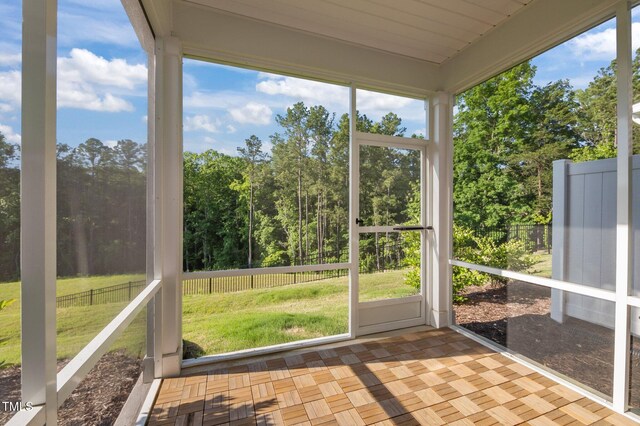 unfurnished sunroom with vaulted ceiling
