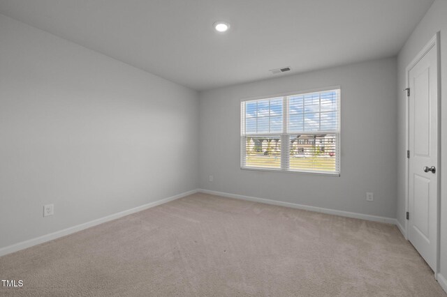 unfurnished bedroom featuring light colored carpet, baseboards, and recessed lighting