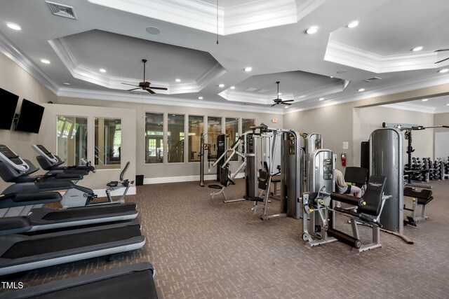 workout area featuring a ceiling fan, a tray ceiling, crown molding, and recessed lighting