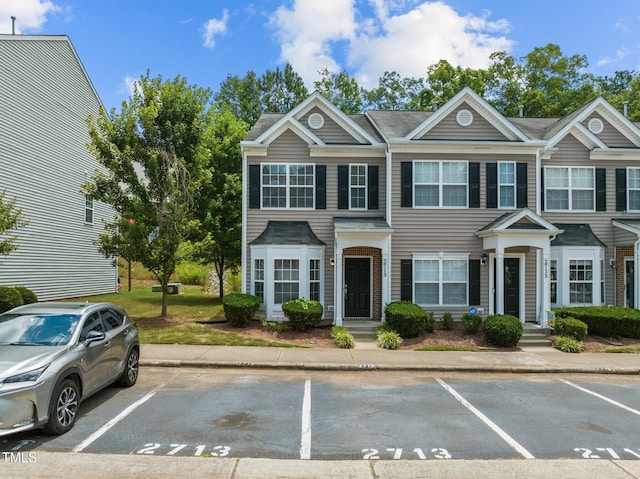townhome / multi-family property featuring uncovered parking
