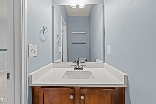 bathroom with vanity and toilet