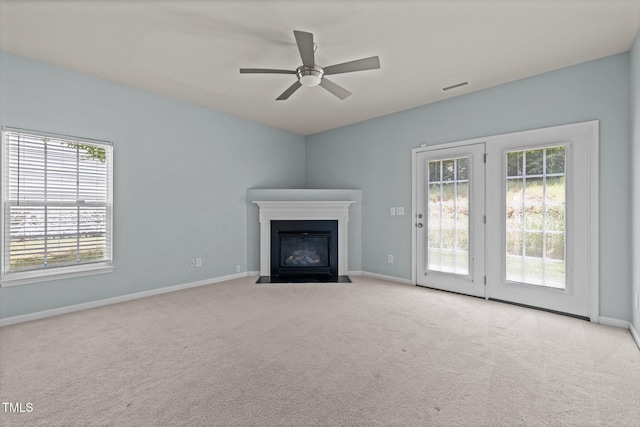 unfurnished living room featuring baseboards and plenty of natural light