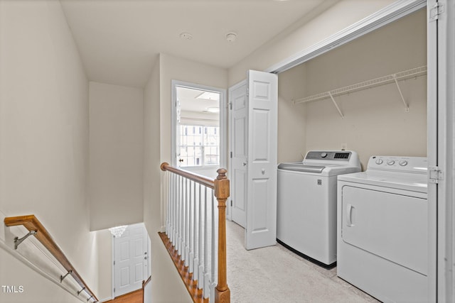 clothes washing area featuring independent washer and dryer and laundry area