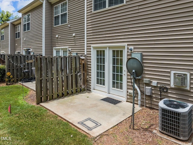 view of patio with central AC and fence