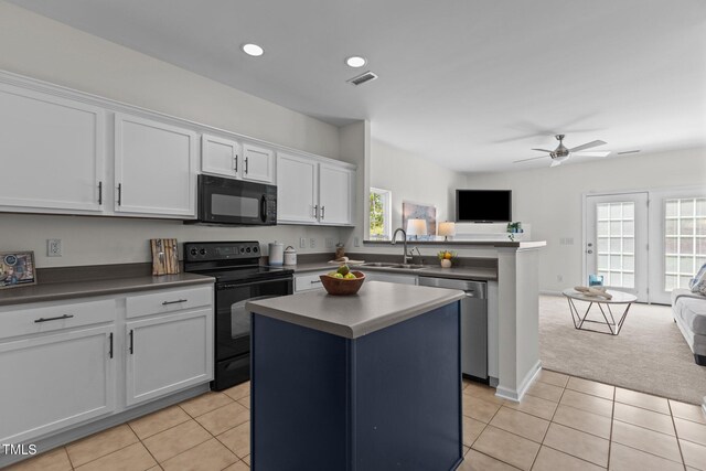 2713 Wyntercrest Ln, Durham, NC 27713 - kitchen featuring visible vents, open floor plan, white cabinetry, a sink, and black appliances