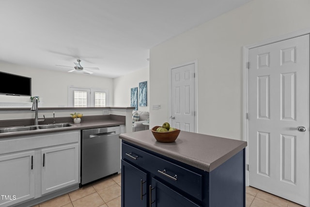 2713 Wyntercrest Ln, Durham, NC 27713 - kitchen featuring light tile patterned flooring, dark countertops, a sink, and dishwasher
