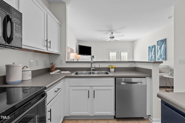 2713 Wyntercrest Ln, Durham, NC 27713 - kitchen with a ceiling fan, a peninsula, white cabinets, a sink, and black appliances