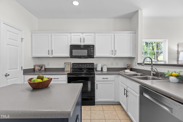 2713 Wyntercrest Ln, Durham, NC 27713 - kitchen with white cabinetry, light tile patterned floors, a sink, and black appliances