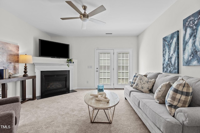 2713 Wyntercrest Ln, Durham, NC 27713 - carpeted living room with a fireplace with flush hearth, ceiling fan, and visible vents