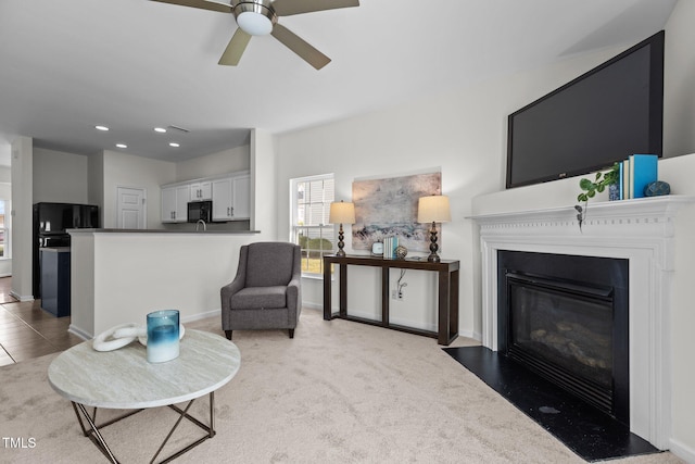 2713 Wyntercrest Ln, Durham, NC 27713 - carpeted living room featuring recessed lighting, a ceiling fan, a fireplace with flush hearth, and baseboards
