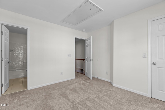 2713 Wyntercrest Ln, Durham, NC 27713 - unfurnished bedroom with baseboards, attic access, ensuite bath, and carpet flooring