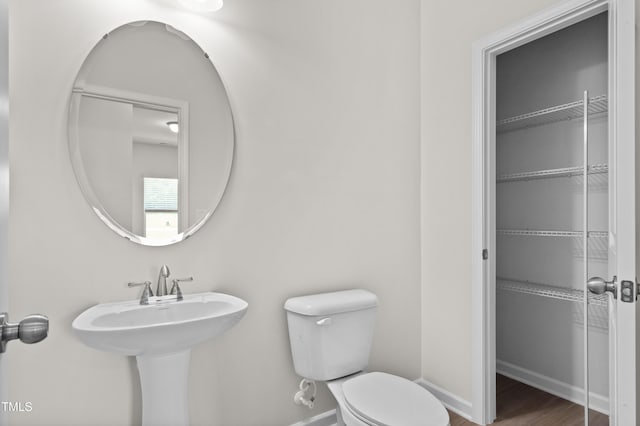 4867 Pioneer Dr, Sanford, NC 27330 - bathroom with toilet, wood finished floors, and baseboards