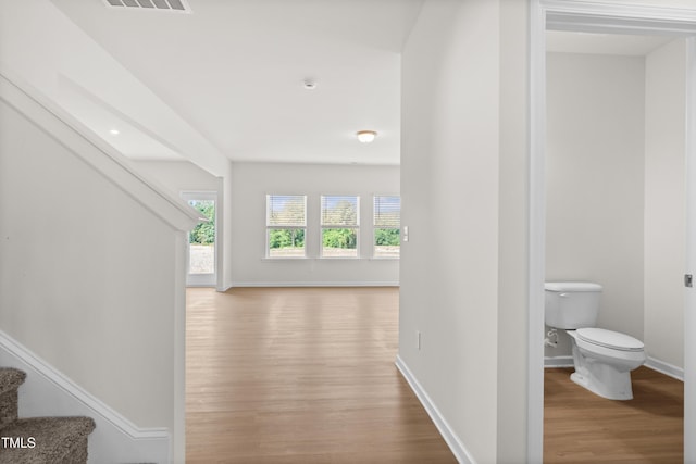 4867 Pioneer Dr, Sanford, NC 27330 - hallway featuring visible vents, baseboards, stairway, and wood finished floors