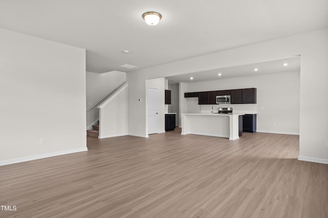 4867 Pioneer Dr, Sanford, NC 27330 - unfurnished living room with visible vents, baseboards, stairway, light wood finished floors, and recessed lighting