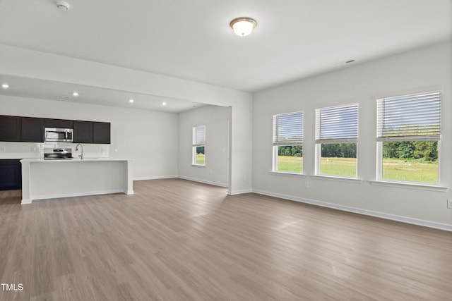 4867 Pioneer Dr, Sanford, NC 27330 - unfurnished living room featuring light wood-style flooring, baseboards, and recessed lighting