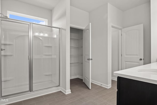 4867 Pioneer Dr, Sanford, NC 27330 - full bath featuring a stall shower, wood finished floors, baseboards, and a walk in closet