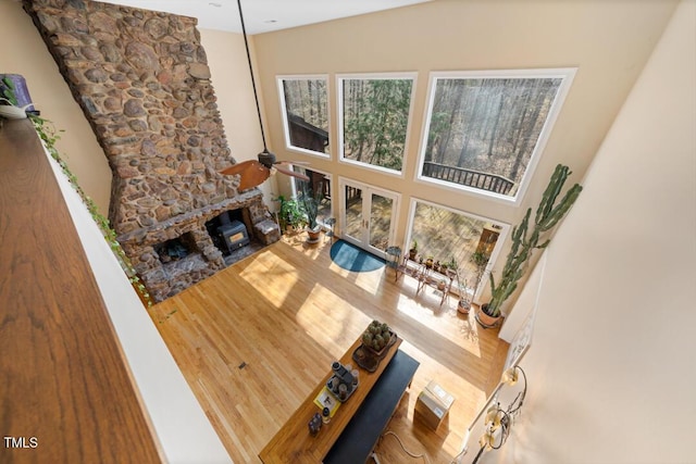 4811 New Sharon Church Rd, Hillsborough, NC 27278 - living area with wood finished floors, a stone fireplace, ceiling fan, and a towering ceiling