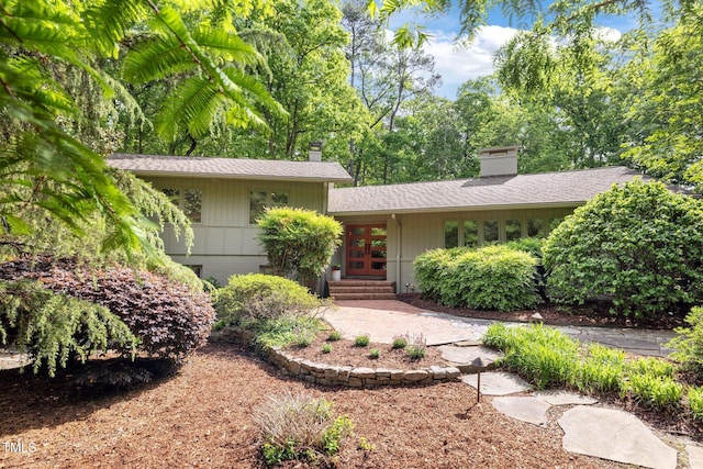 3915 Nottaway Rd, Durham, NC 27707 - view of front of property featuring french doors, a chimney, roof with shingles, and entry steps