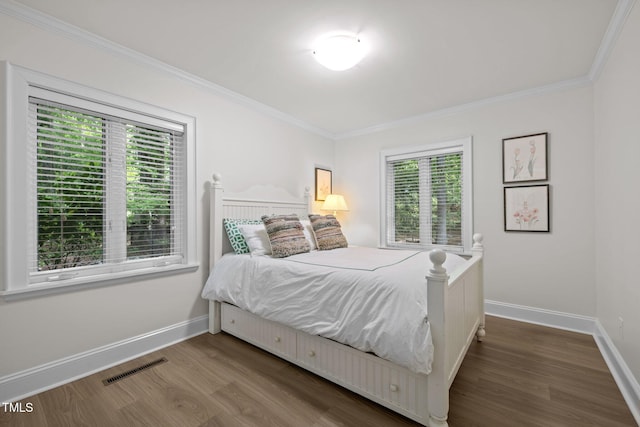 3915 Nottaway Rd, Durham, NC 27707 - bedroom featuring multiple windows, wood finished floors, crown molding, and baseboards