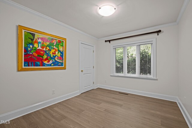 3915 Nottaway Rd, Durham, NC 27707 - spare room featuring wood finished floors, crown molding, and baseboards