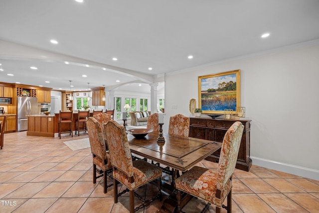 3915 Nottaway Rd, Durham, NC 27707 - dining space featuring decorative columns, arched walkways, recessed lighting, ornamental molding, and baseboards