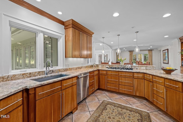 3915 Nottaway Rd, Durham, NC 27707 - kitchen with stainless steel appliances, a sink, light stone countertops, decorative light fixtures, and brown cabinets