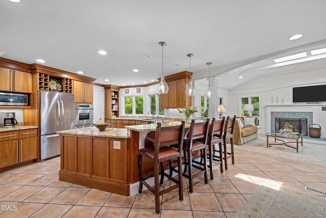 3915 Nottaway Rd, Durham, NC 27707 - kitchen with stainless steel appliances, open shelves, brown cabinetry, a peninsula, and recessed lighting