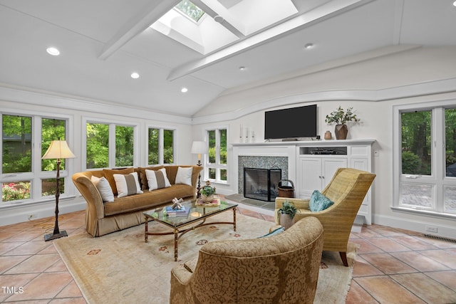 3915 Nottaway Rd, Durham, NC 27707 - living room with a skylight, lofted ceiling, a fireplace, recessed lighting, and light tile patterned floors