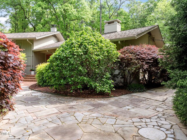 3915 Nottaway Rd, Durham, NC 27707 - view of property exterior with a chimney and roof with shingles