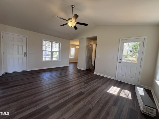 entryway featuring lofted ceiling, baseboards, dark wood-type flooring, and a ceiling fan