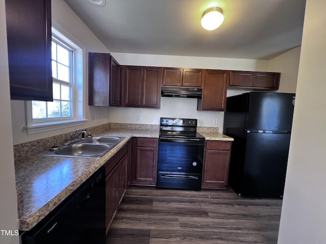 kitchen featuring dark wood finished floors, a sink, black appliances, dark brown cabinetry, and under cabinet range hood