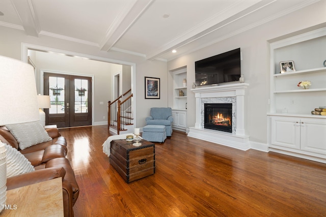 301 Rocking Ranch Ct, Cary, NC 27519 - living room with built in features, wood finished floors, beam ceiling, ornamental molding, and a fireplace