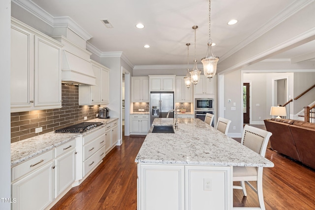 301 Rocking Ranch Ct, Cary, NC 27519 - kitchen featuring appliances with stainless steel finishes, a breakfast bar area, dark wood-type flooring, backsplash, and open floor plan
