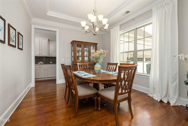 301 Rocking Ranch Ct, Cary, NC 27519 - dining space featuring plenty of natural light, dark wood-style floors, a chandelier, and ornamental molding