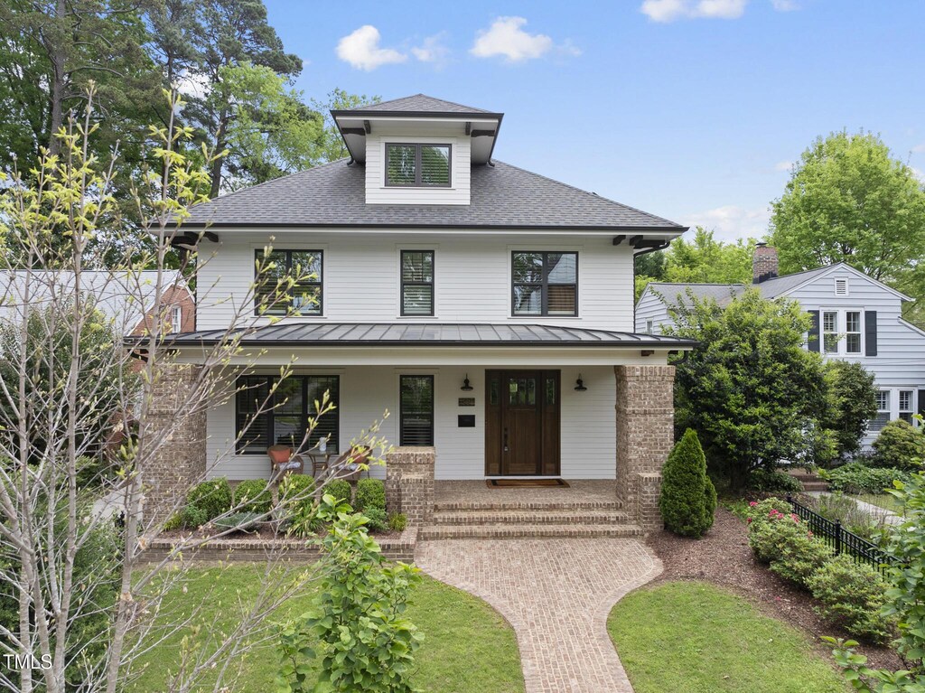 1306 Mordecai Dr, Raleigh, NC 27604 - american foursquare style home with roof with shingles, a porch, a standing seam roof, metal roof, and fence