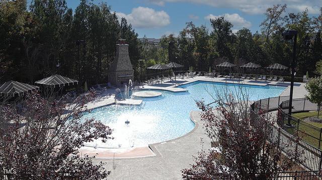 pool featuring fence and a patio area