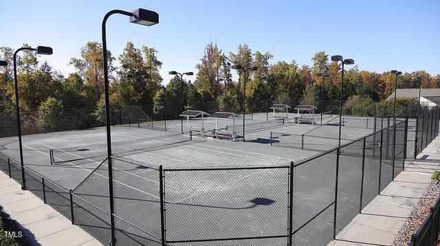 view of sport court featuring fence