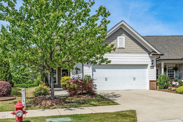 view of front of home with driveway and a garage
